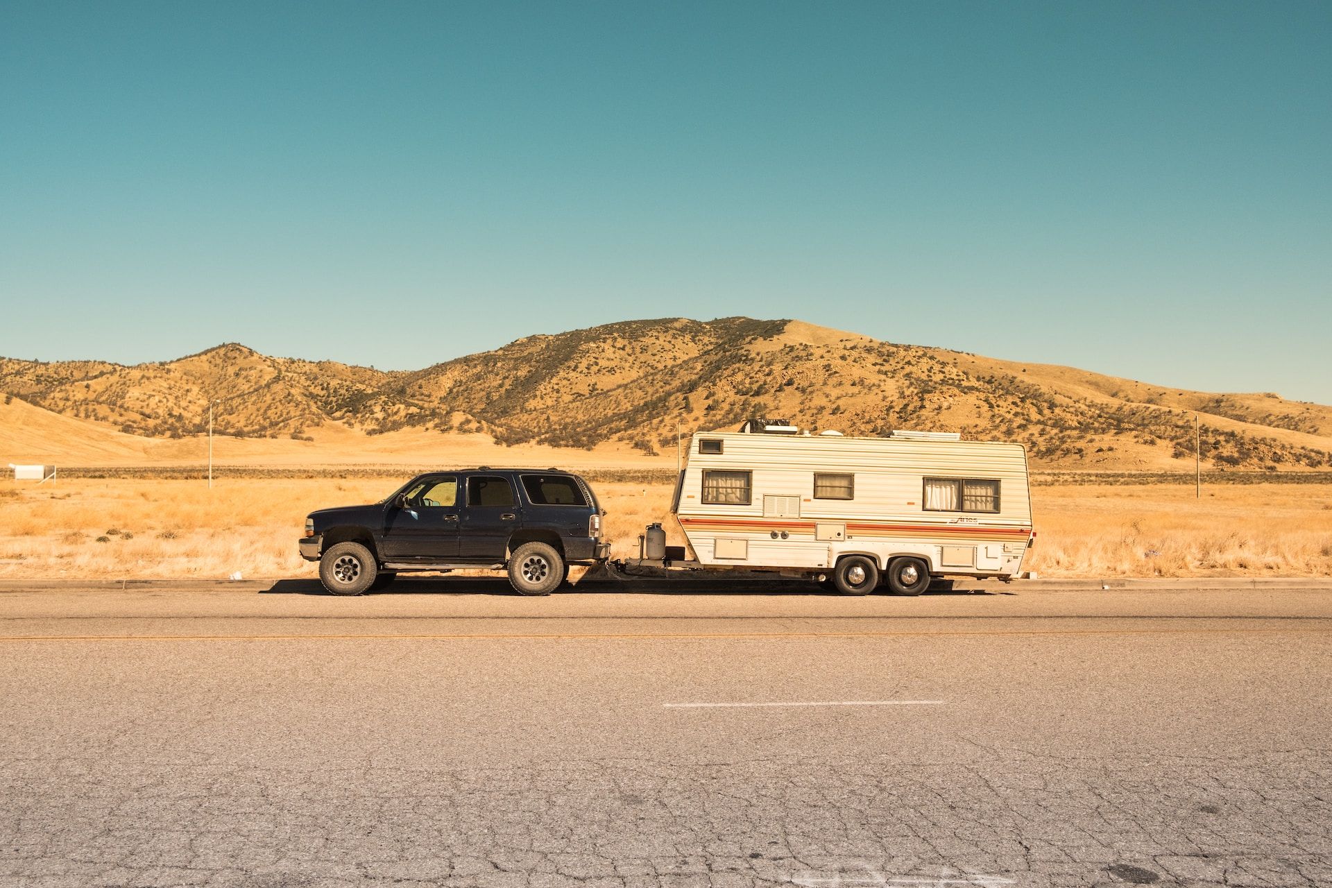 A Black SUV and A White Trailer On The Road In California, United States