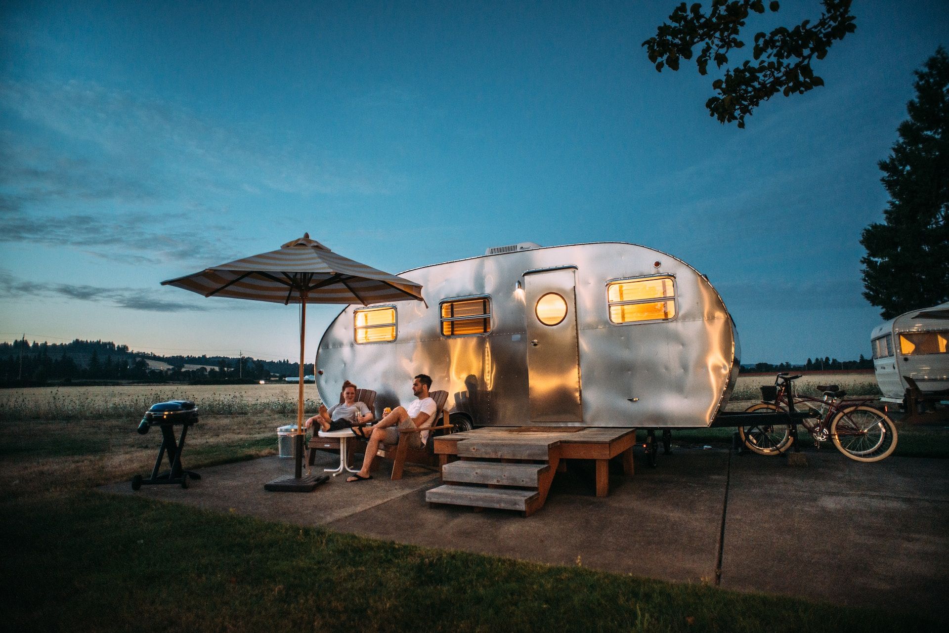 People Seated Outside A Trailer In Oregon, USA