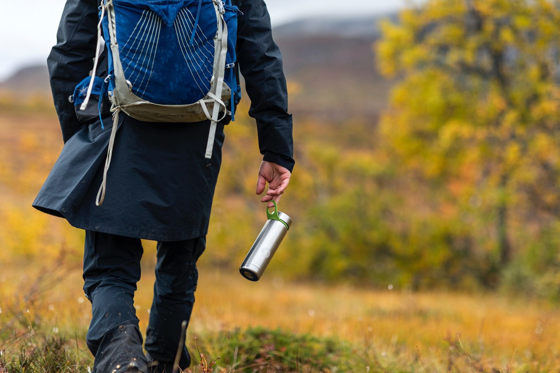 Hiker carrying a reusable water bottle 