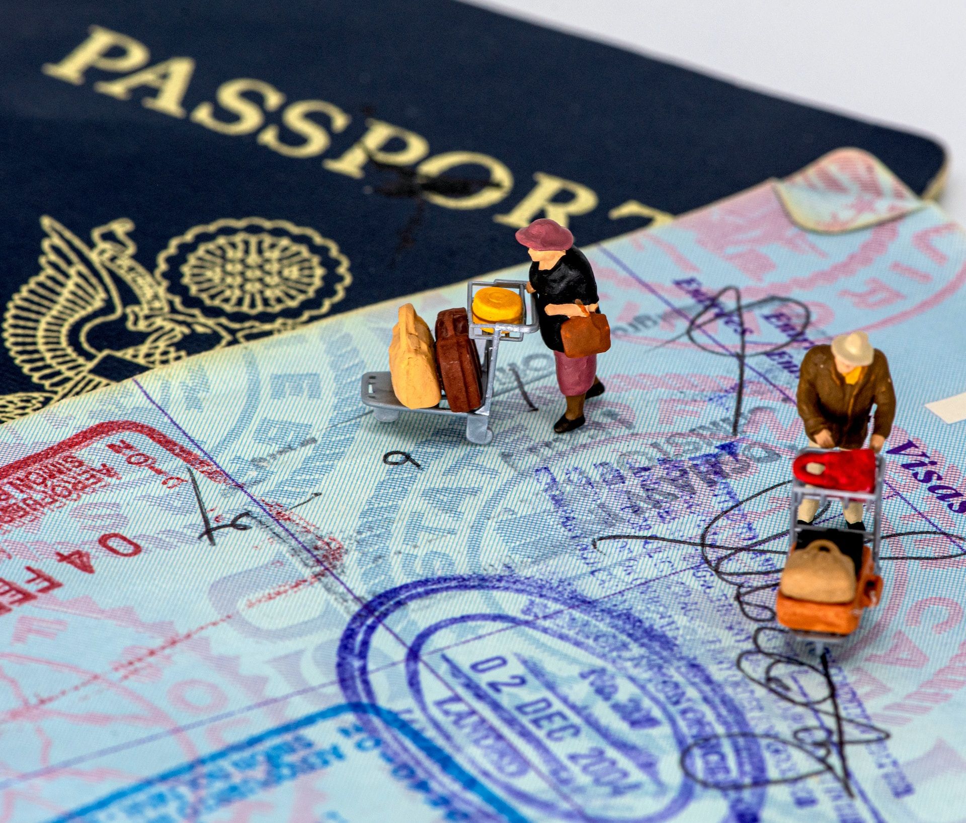 Image of two figurines walking on a passport page