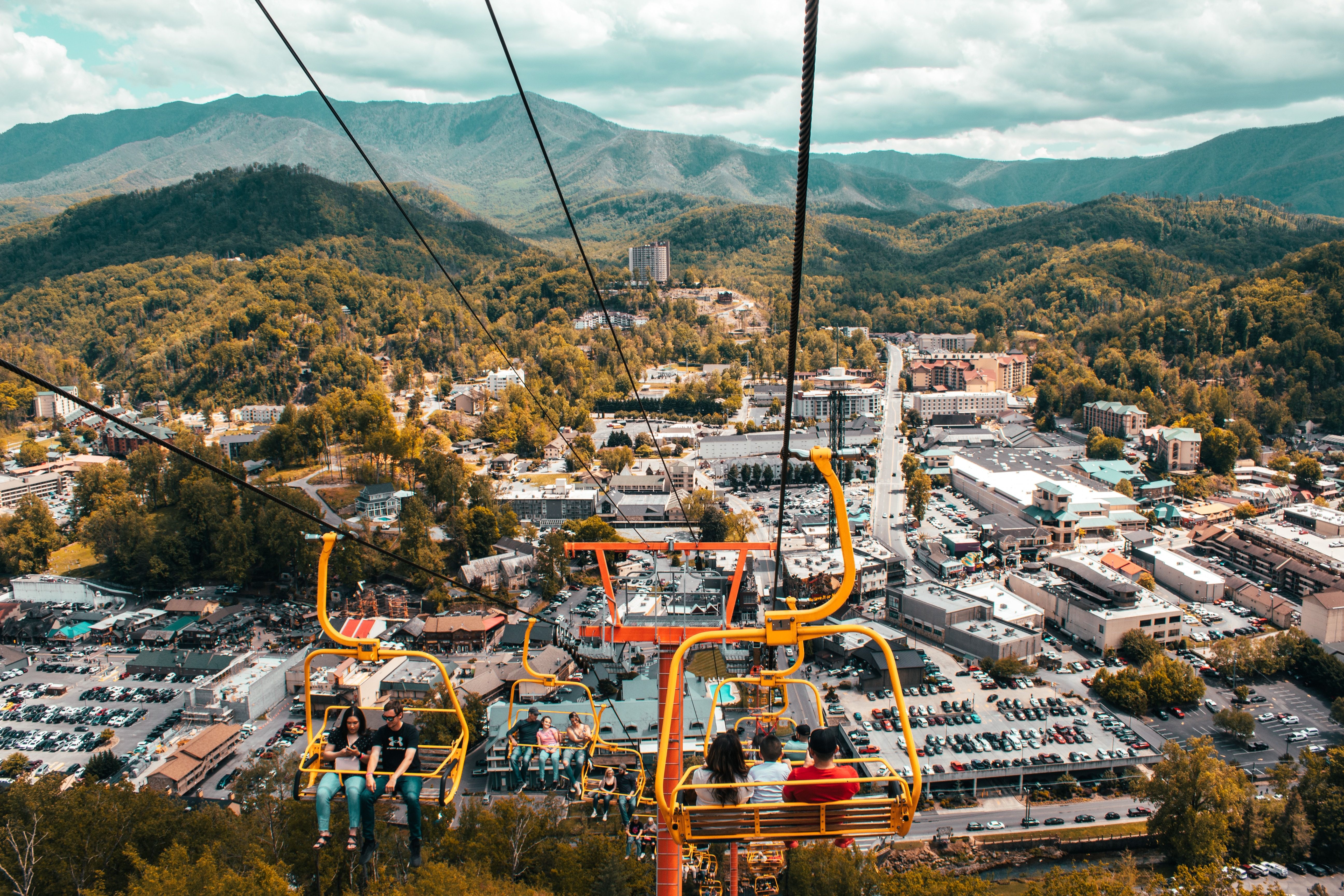 People riding cable cars in Pigeon Forge to see fall foliage from a different point in Tennessee, United States