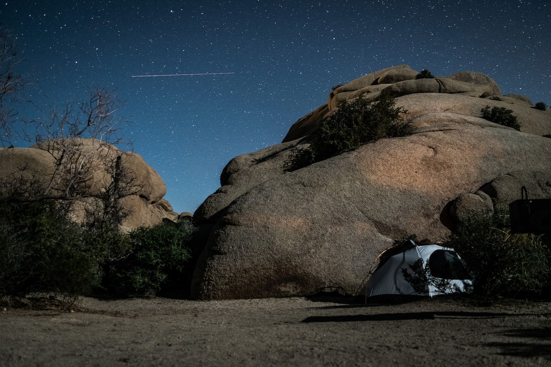 A tent near a large rock in Joshua Tree National Park 