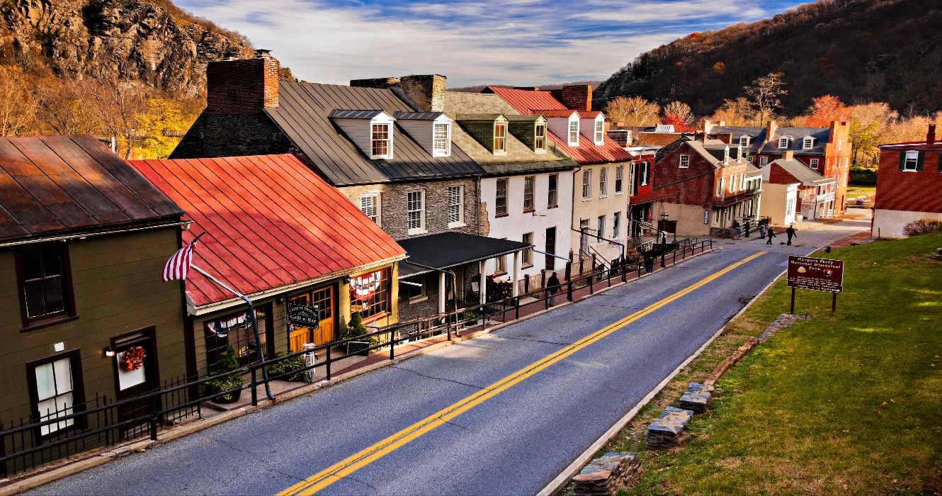 Shops and historic buildings surrounded by fall foliage in the autumn on High Street in Harper's Ferry, West Virginia, USA