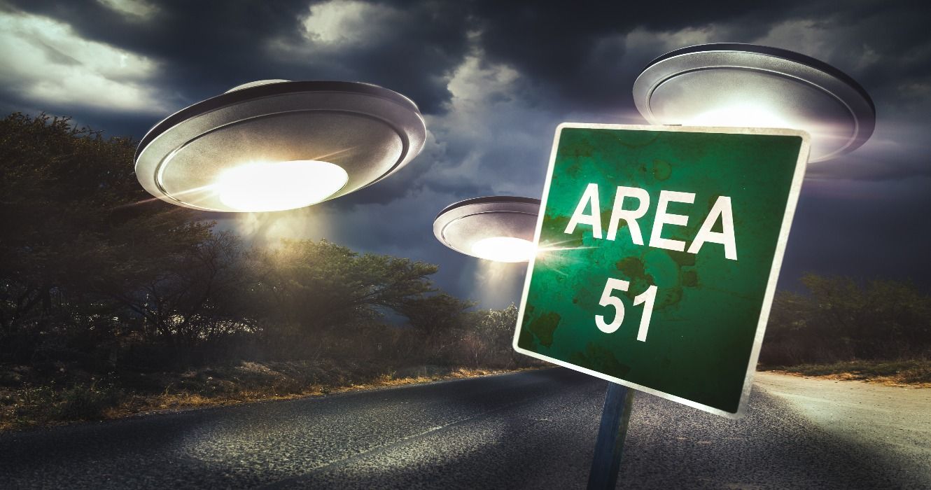 An artist's impression of a sign for Area 51 in Nevada, USA, with UFOs surrounding it