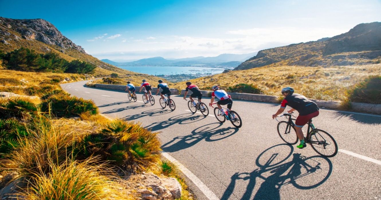 Group of triathletes on a bicycle ride, biking on a road in Mallorca, Majorca, Spain