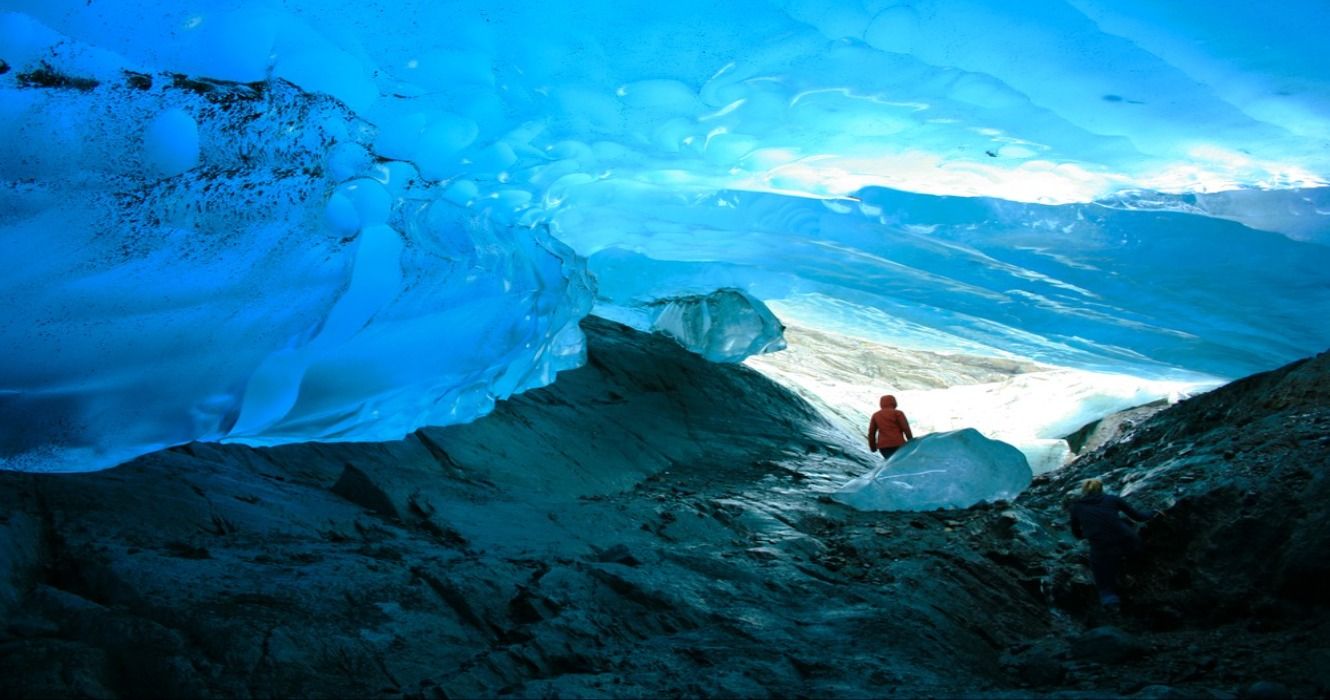 A person inside the Mendenhall Ice Cave at the Mendenhall Glacier, Juneau, Alaska, USA