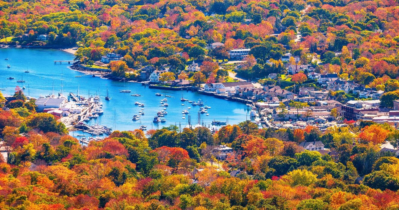 A view of fall foliage in the autumn seen from Mount Battie overlooking Camden harbor, Maine, ME, New England, USA