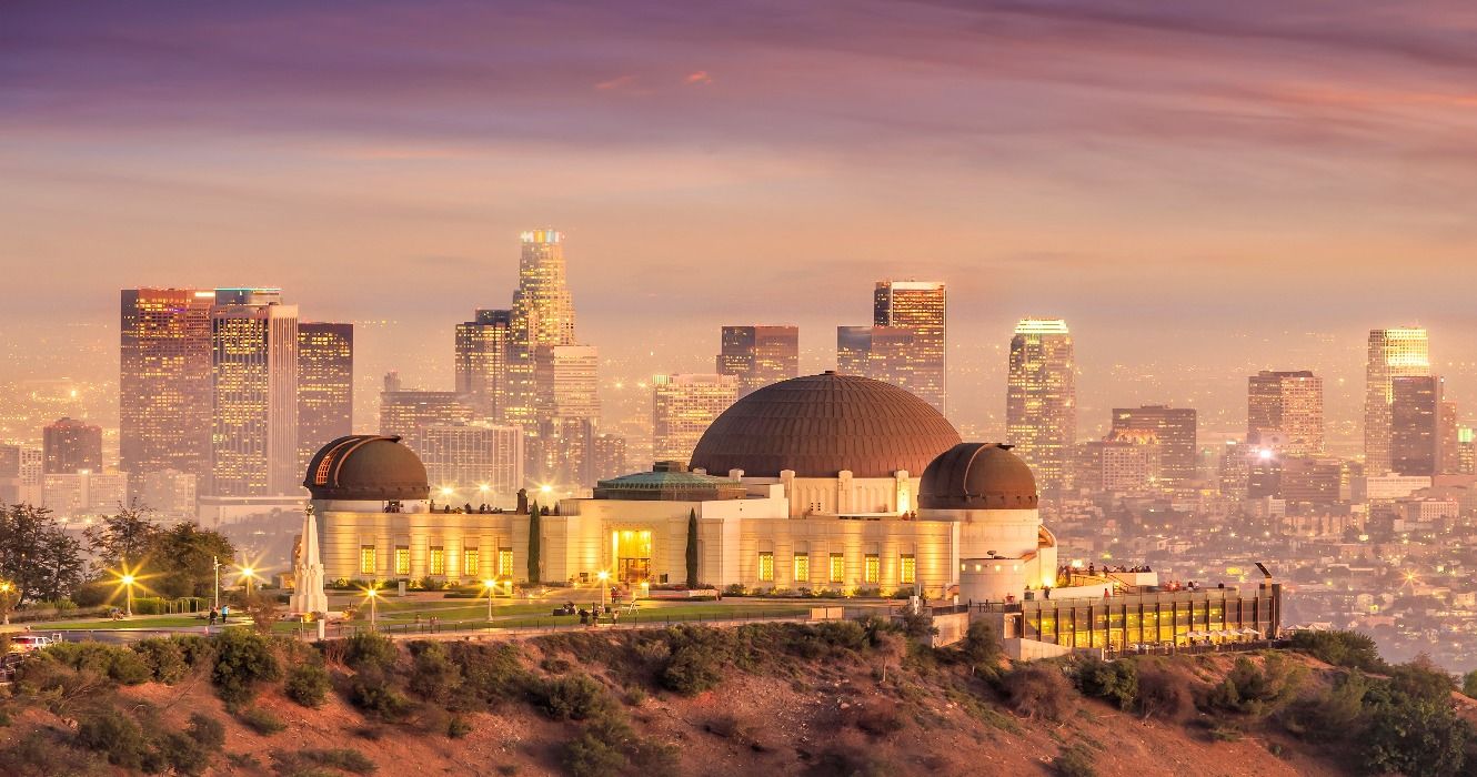 The Griffith Observatory at sunset with the LA city skyline in the background, Los Angeles, California, USA