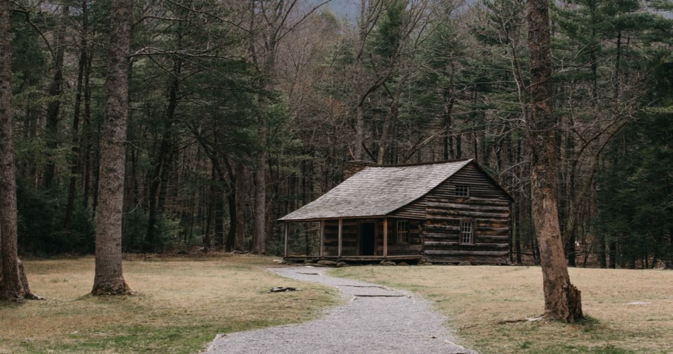 Landscape view of a wooden cabin in the woods in Cades Cove, Great Smoky Mountains, Tennessee, USA