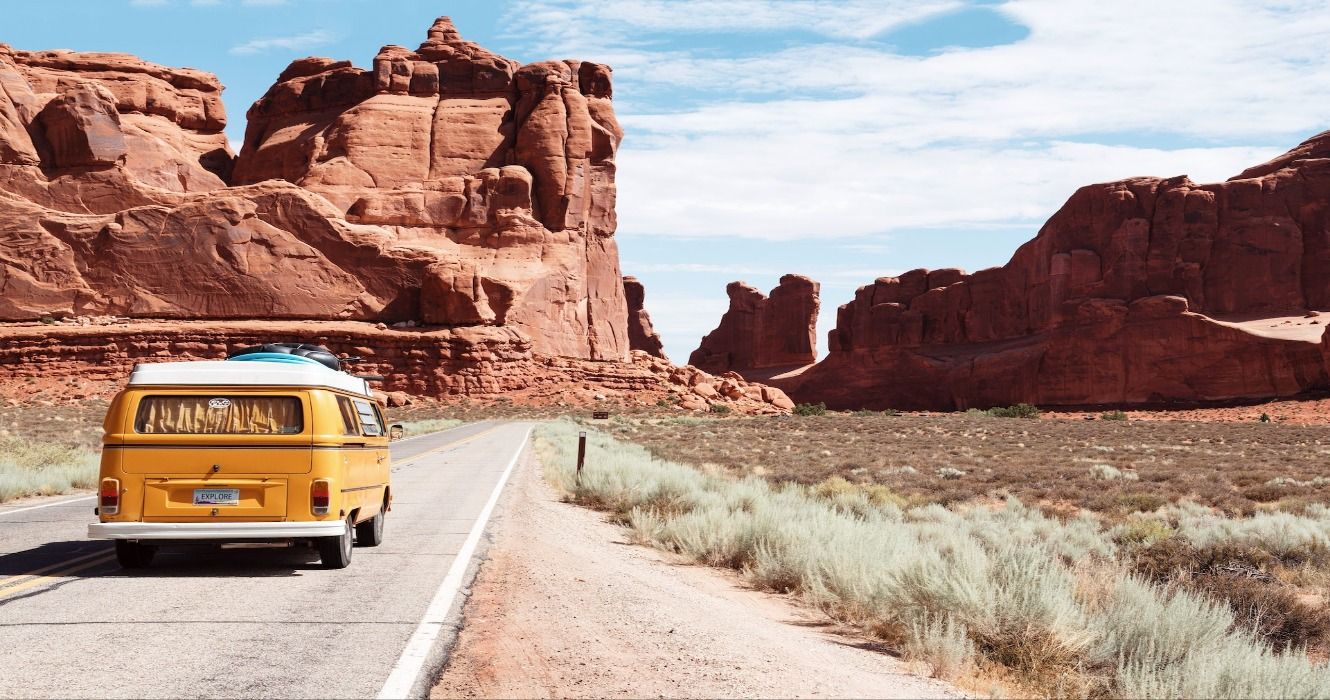 A Yellow Volkswagen camper van at the Arches National Park Entrance Station, Moab, United States