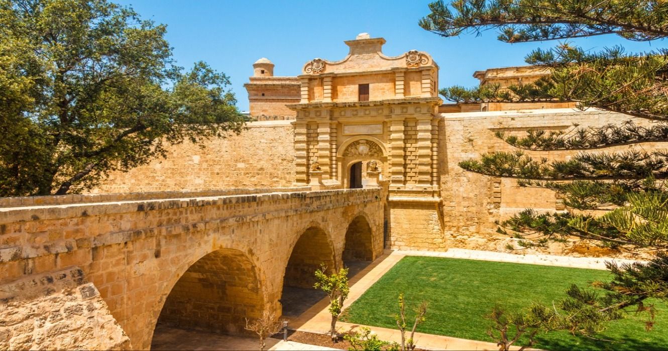Entrance bridge and the gate to the ancient city of Mdina, a fortified medieval city in Malta's nothern region, Europe