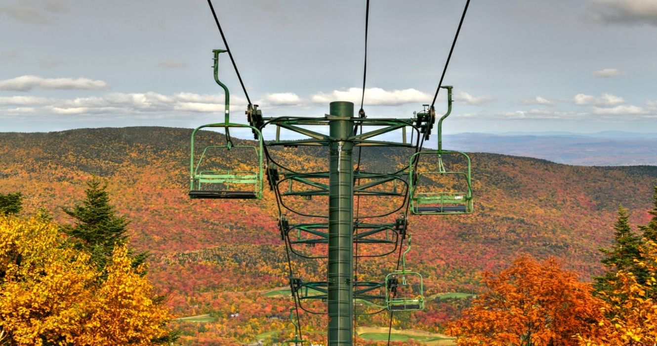 Vermont fall foliage views and a ski lift amid a forest on Mount Mansfield in Vermont, USA