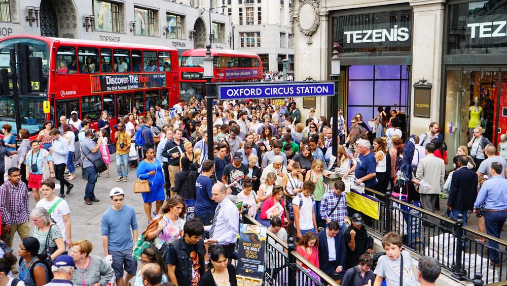 Shoppers and commuters on the street at the famous Oxford Circus Station in downtown London, England, UK, United Kingdom