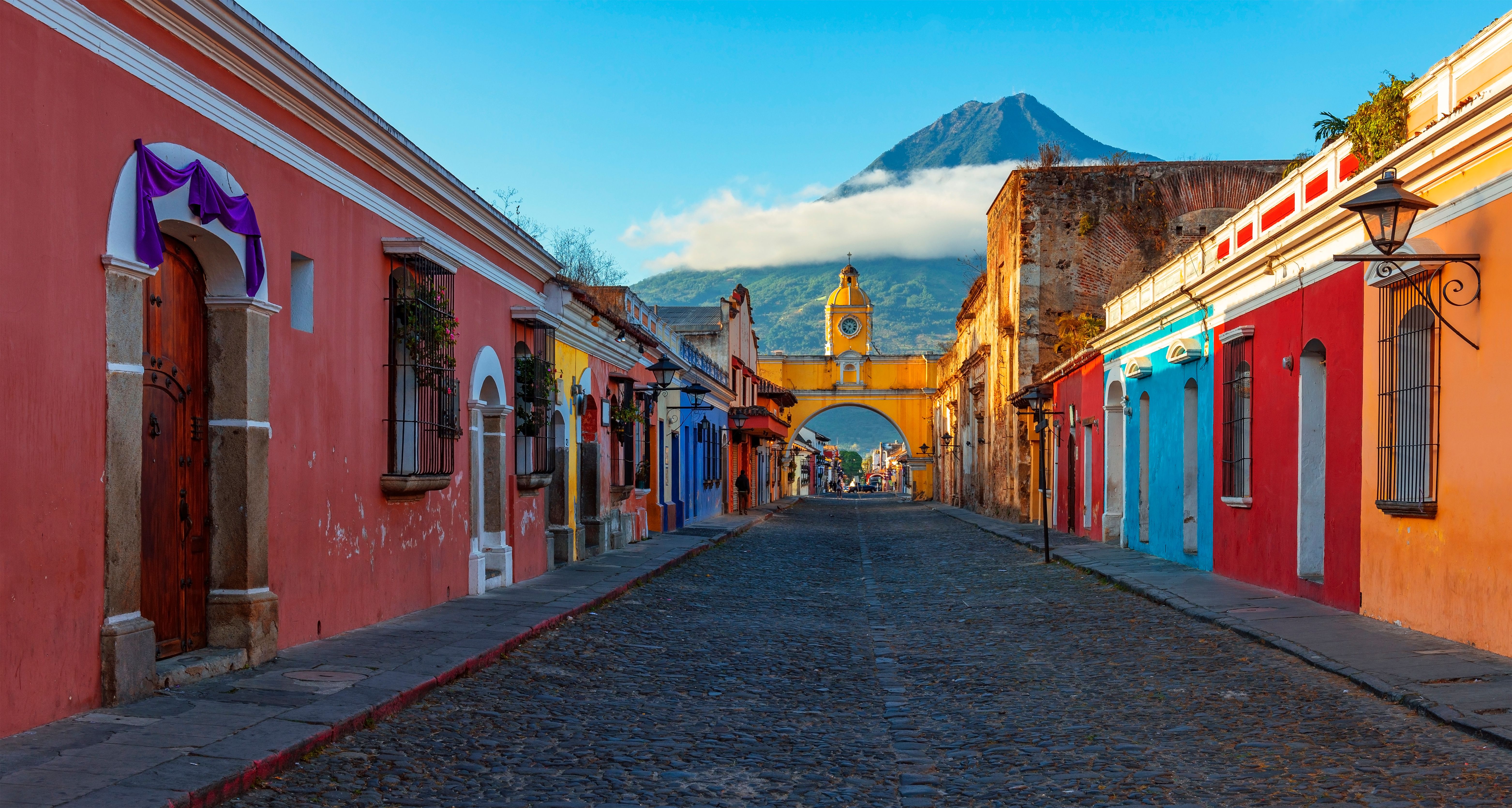 Colorful street with volcano in the distance 