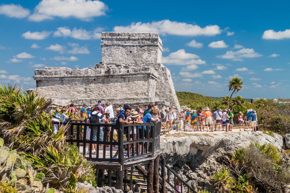 Tourists visiting the Mayan ruins of the ancient Maya city of Tulum, Mexico