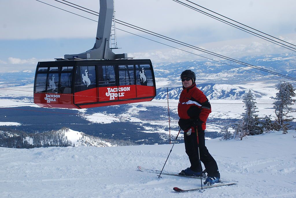 Male skier beside tram in Jackson Hole in Jackson Hole, Wyoming USA