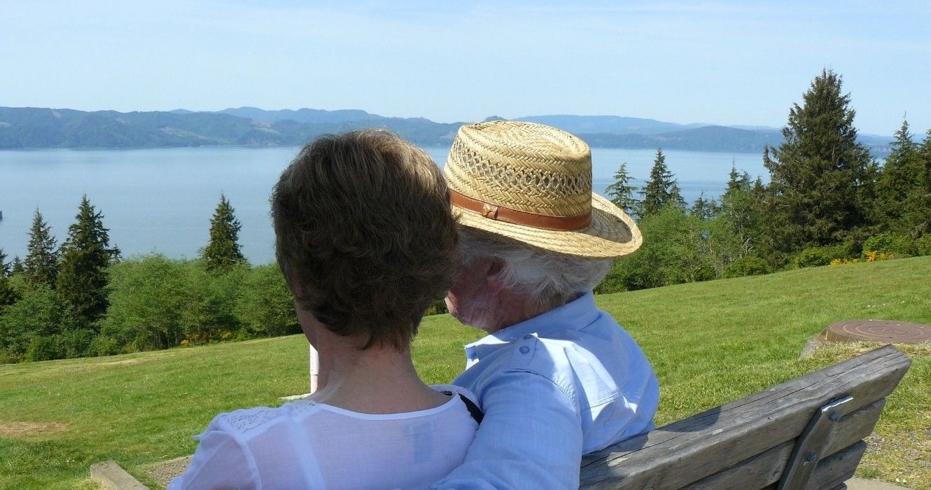 A couple on a bench looking at Youngs Bay in Astoria, Oregon
