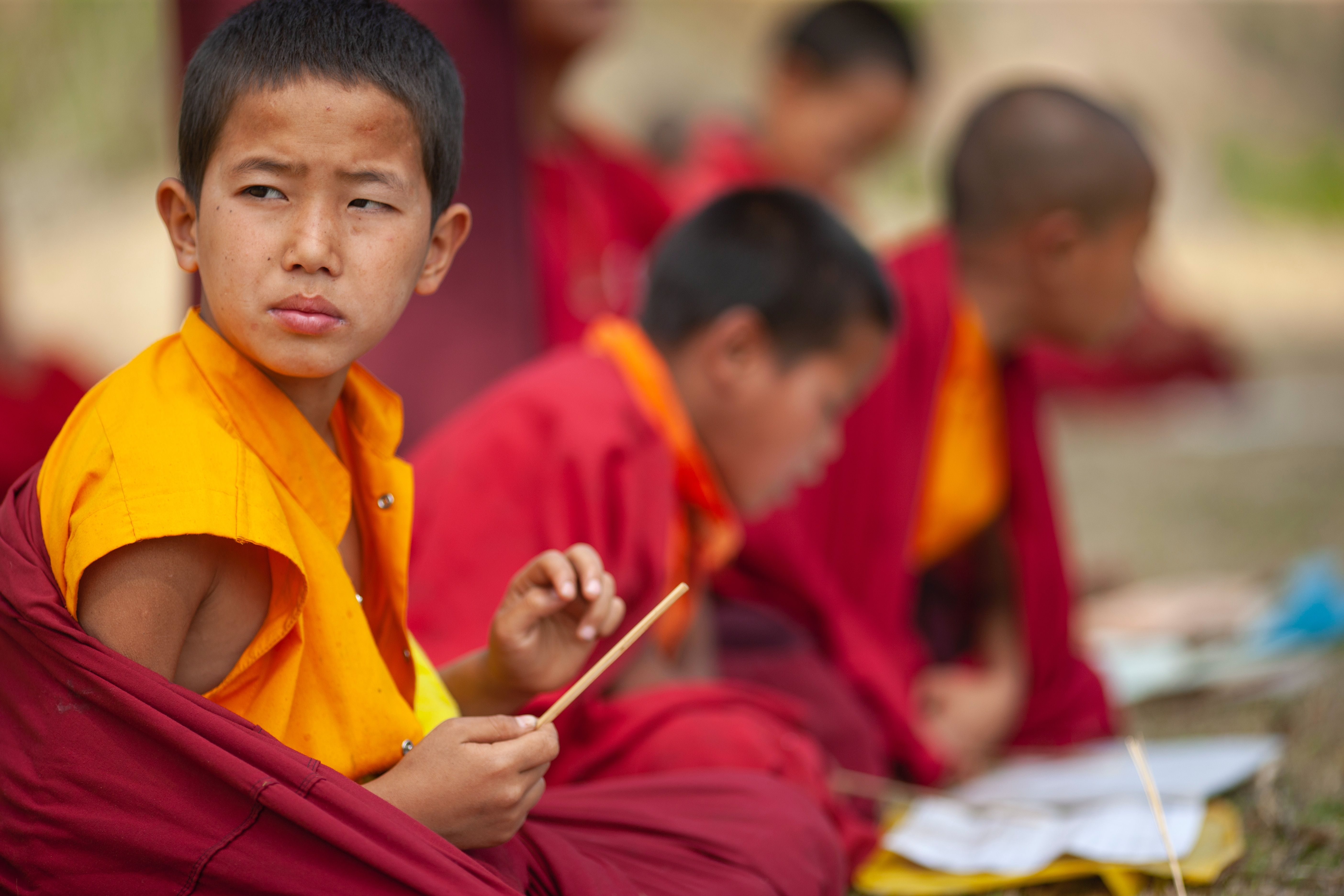 Group of young Buddhist monks who are studying in an outdoor class
