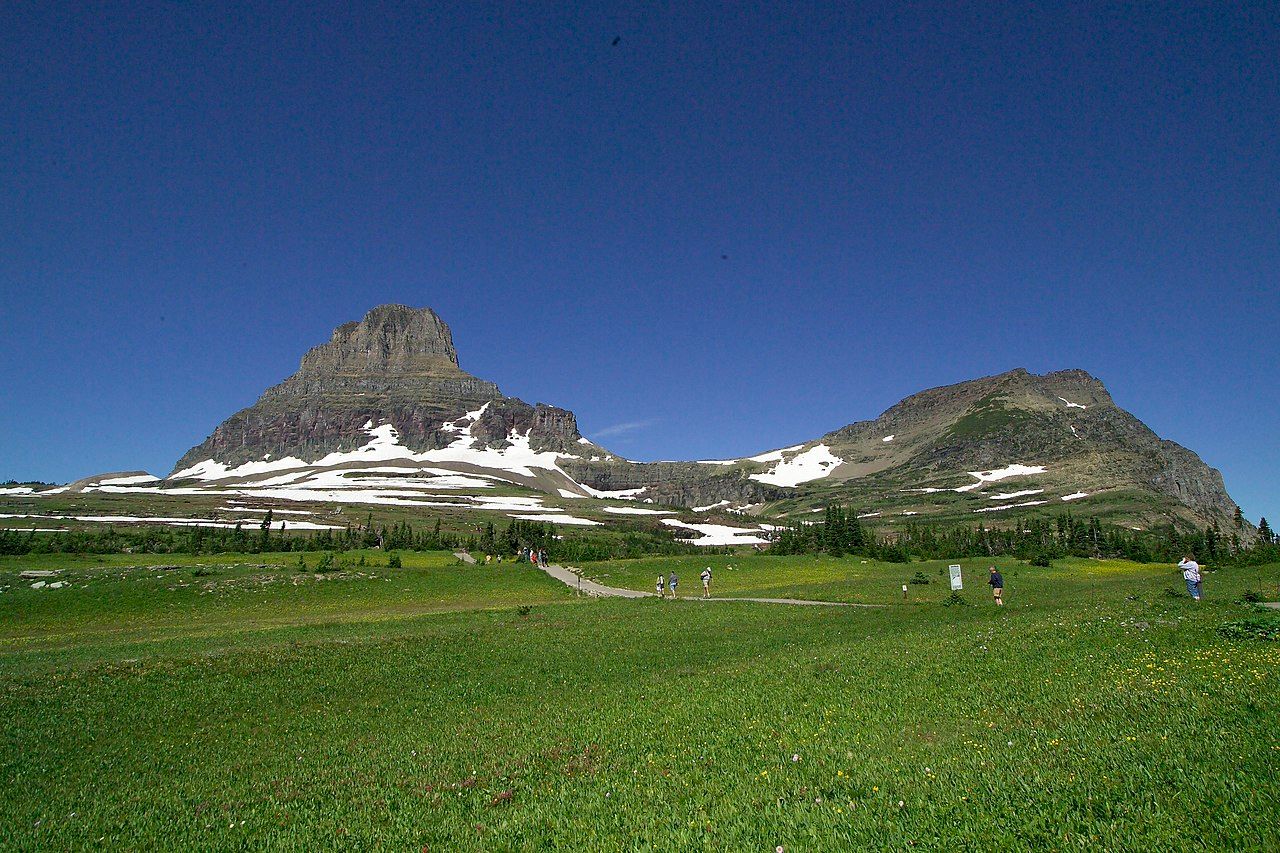 Visitors to the Logan Pass area start up the trail to Hidden Lake Overlook. Mt. Oberlin 