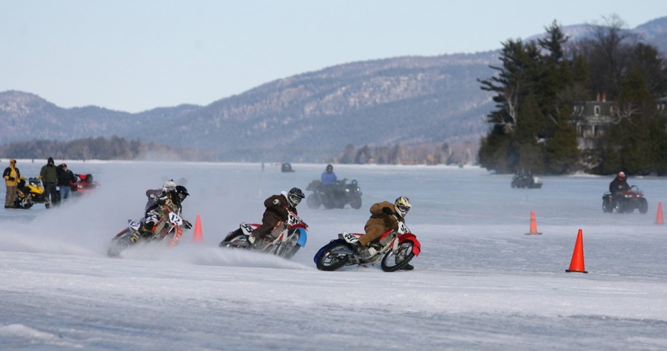 Motorcycles race on the frozen lake during the Winter Carnival, Lake George, New York