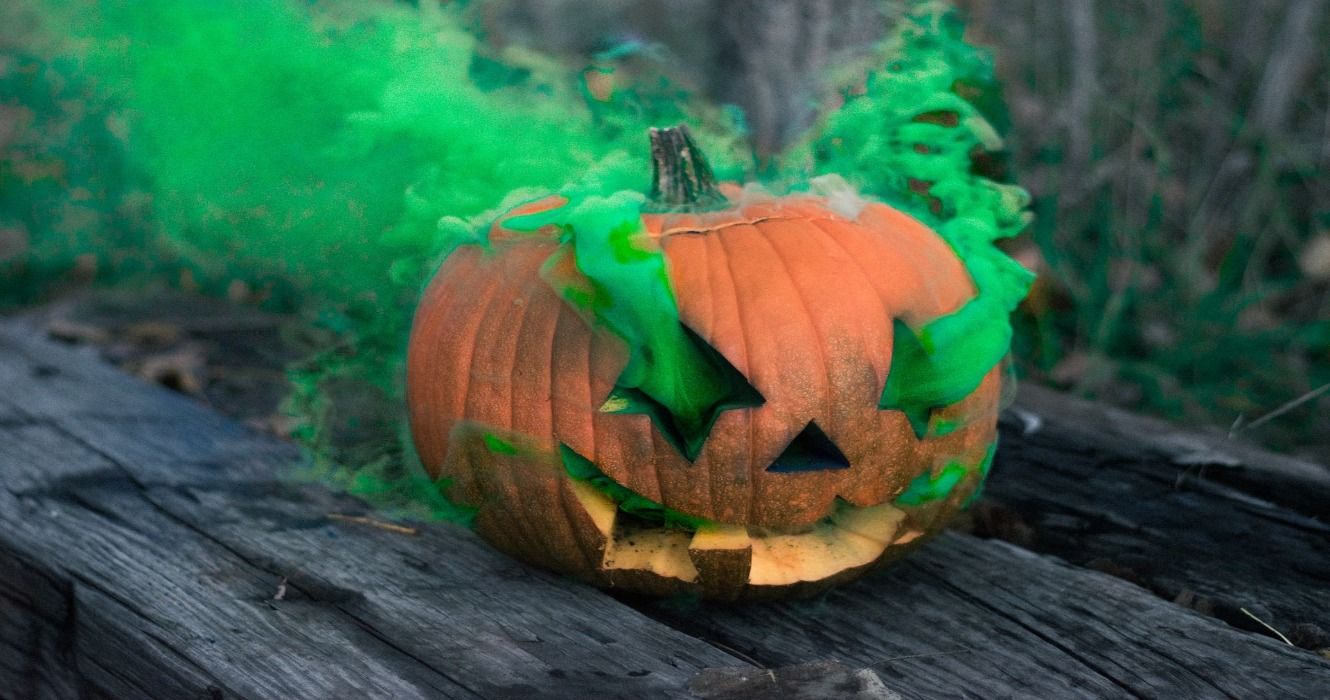 A Jack O' Lantern pumpkin with green smoke on Halloween in the USA