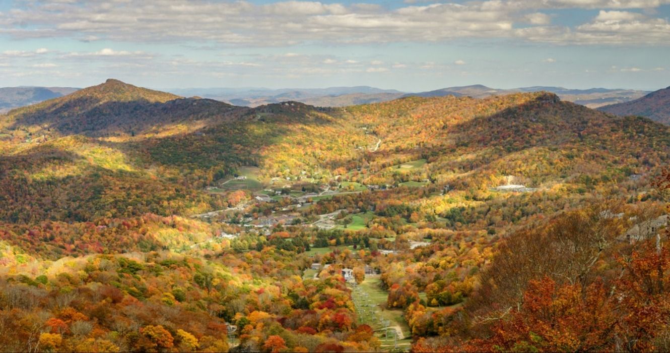 Fall foliage in the autumn seen from the top of Sugar Mountain looking over Tyne Castle in the town of Banner Elk, North Carolina, Blue Ridge Mountains, USA