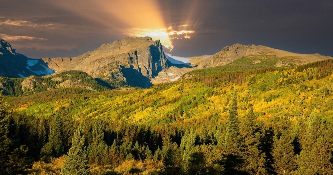 View of mountains and fall foliage in the autumn beginning to emerge around Bear Lake in Rocky Mountain National Park, Colorado, USA