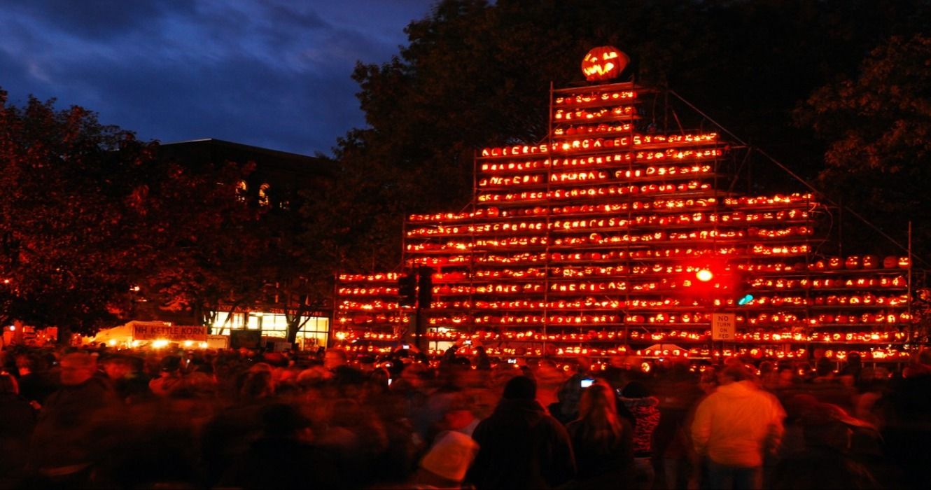 A crowd at the tower of pumpkins during the pumpkin festival in Keene, NH, New Hampshire, New England, USA