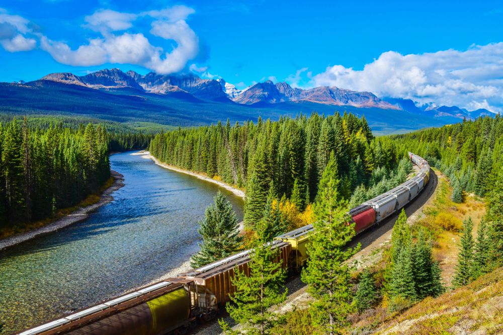Train moving along Bow River in Canadian Rockies, Banff National Park