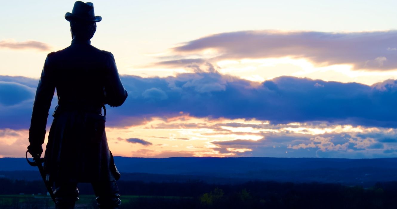 Statue of a soldier looking over Gettysburg PA at sunset