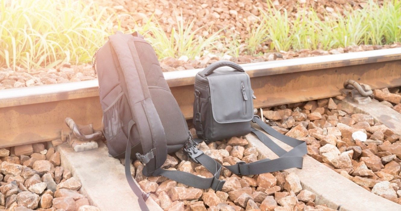 Backpack and sling bag on railway