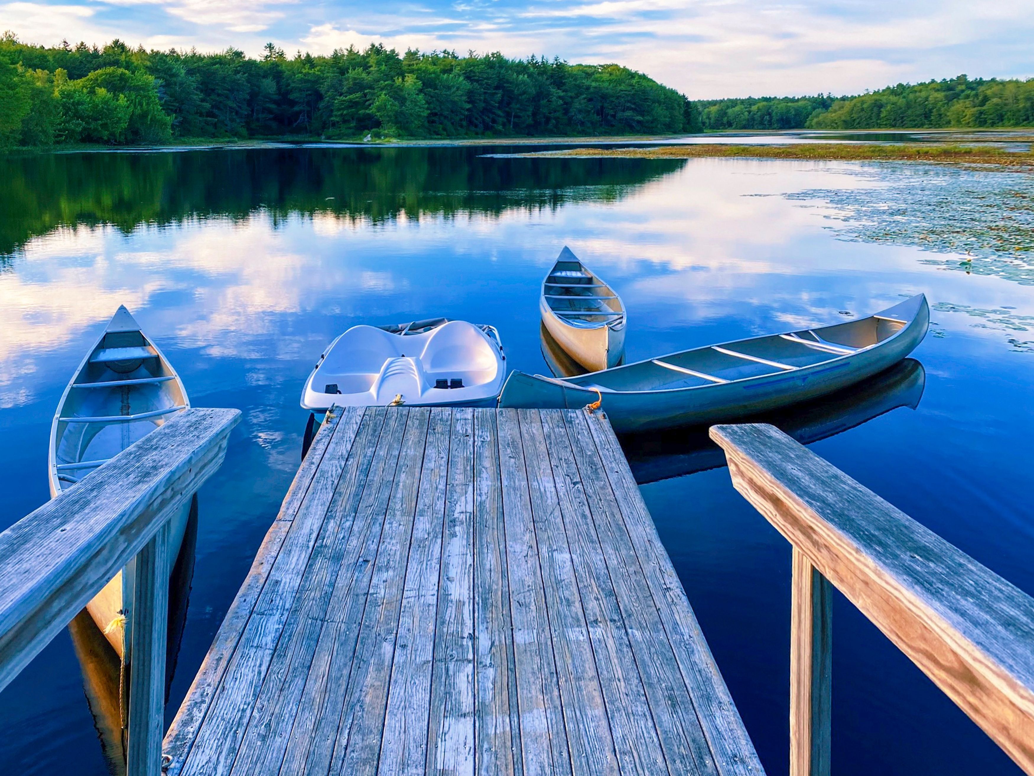 Canoes on a lake dock in Maine