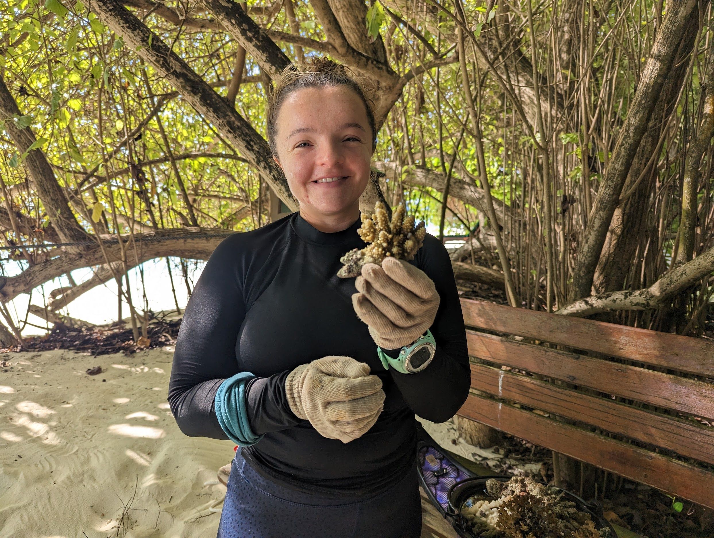 Rosalie Bailie, Marine Educator at Coco Collection holds a coral fragment soon to be planted 