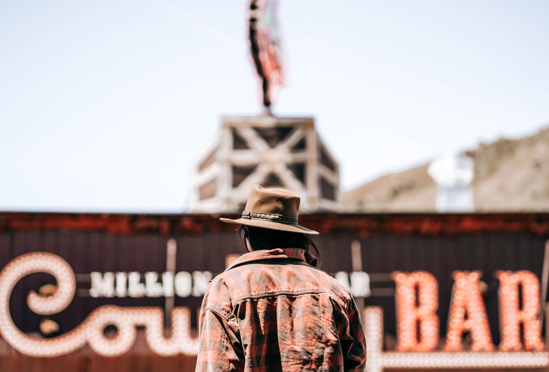 A man stands in front of the famous Cowboy Bar in Jackson, Wyoming