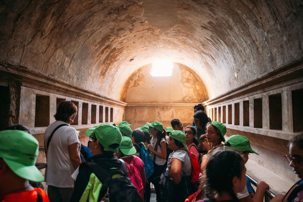 Group Of School children Visiting Antique Roman Bathhouse in Pompeii