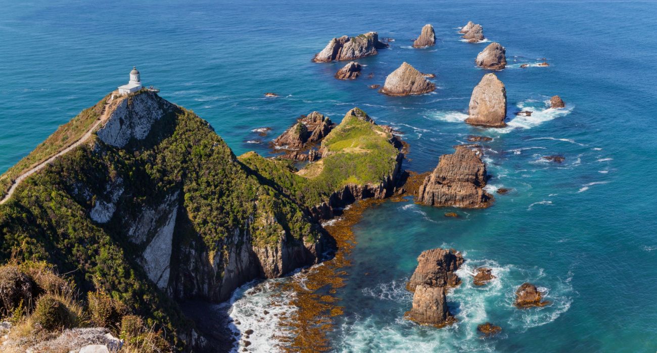 Nugget Point Lighthouse and rocky islets picturesque view, Catlins, New Zealand