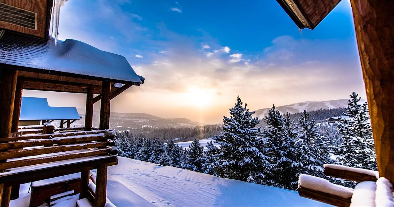 Sunrise above the snow and ski slopes amid the ski resorts during winter in Big Sky, Montana, MT, USA