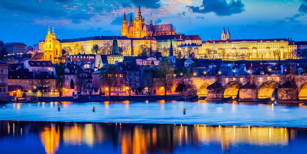 Panorama of Prague Castle and St. Vitus Cathedral in twilight with dramatic sky