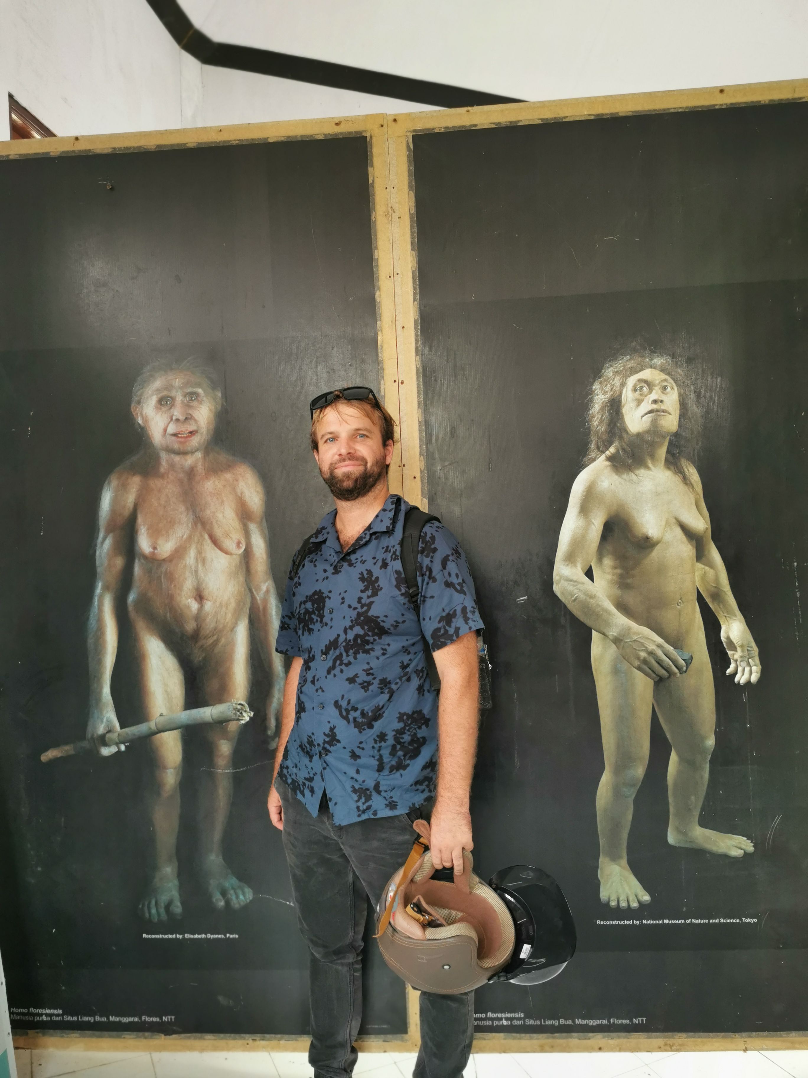 Tourist at Homos Floresiensis museum with artistic reproductions of the archaic humans