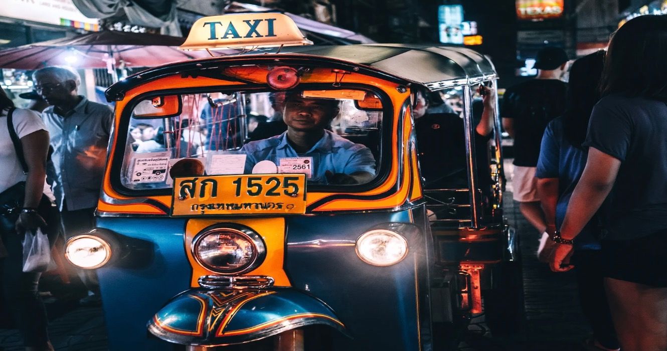 Thai taxi driver in the city at night