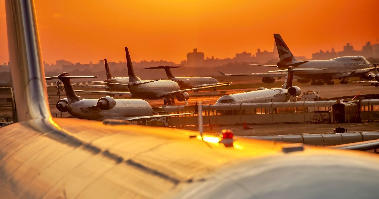 Airplanes at sunset along the runway at JFK international airport.
