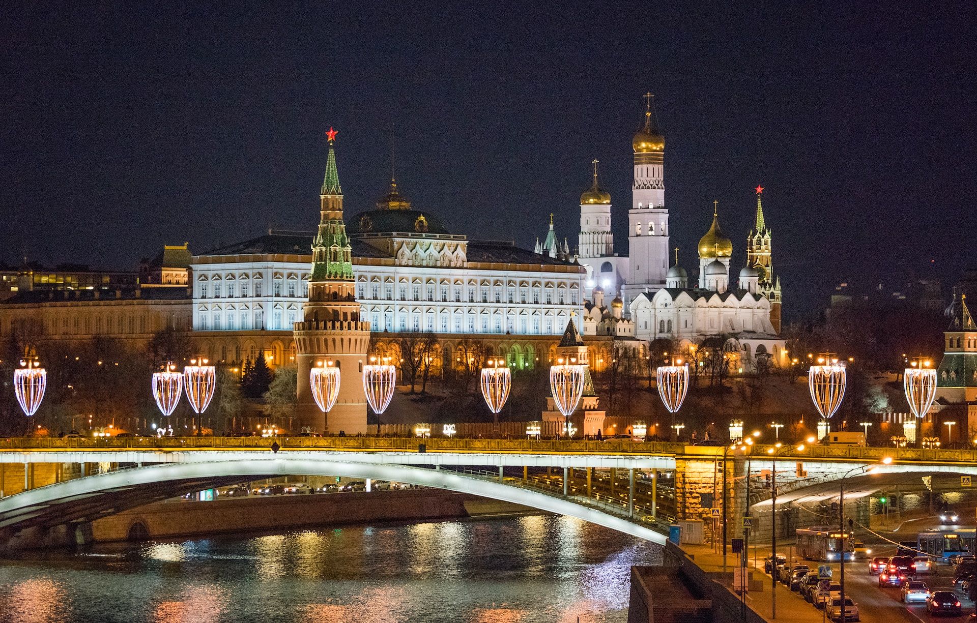 Moscow Kremlin at night with lights and a river in the foreground