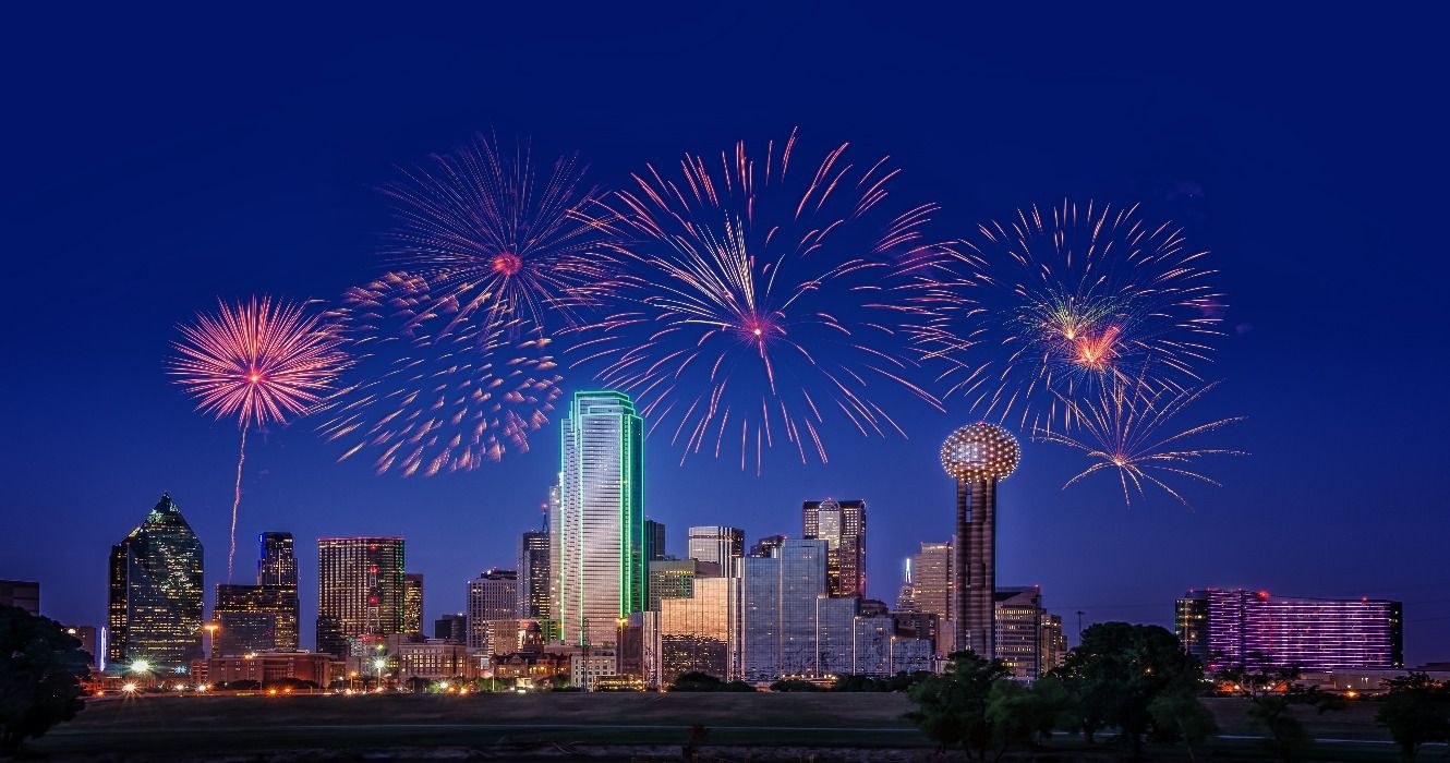 Cityscape of Dallas at night, TX, Texas, USA, with fireworks