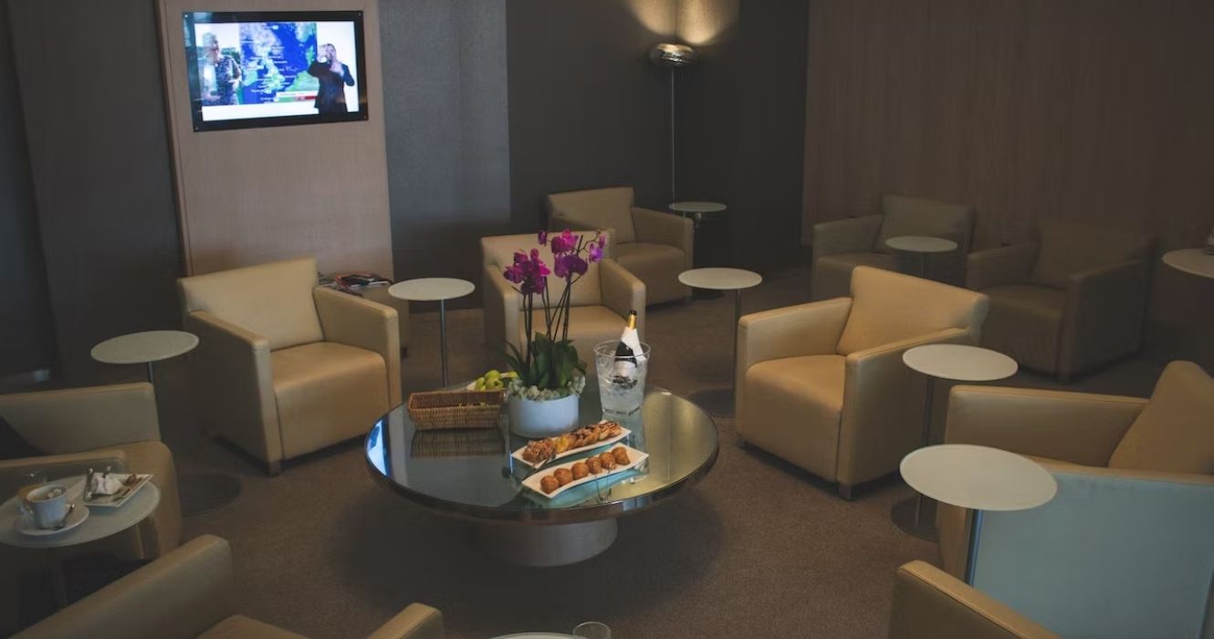 An airport lounge with chairs 