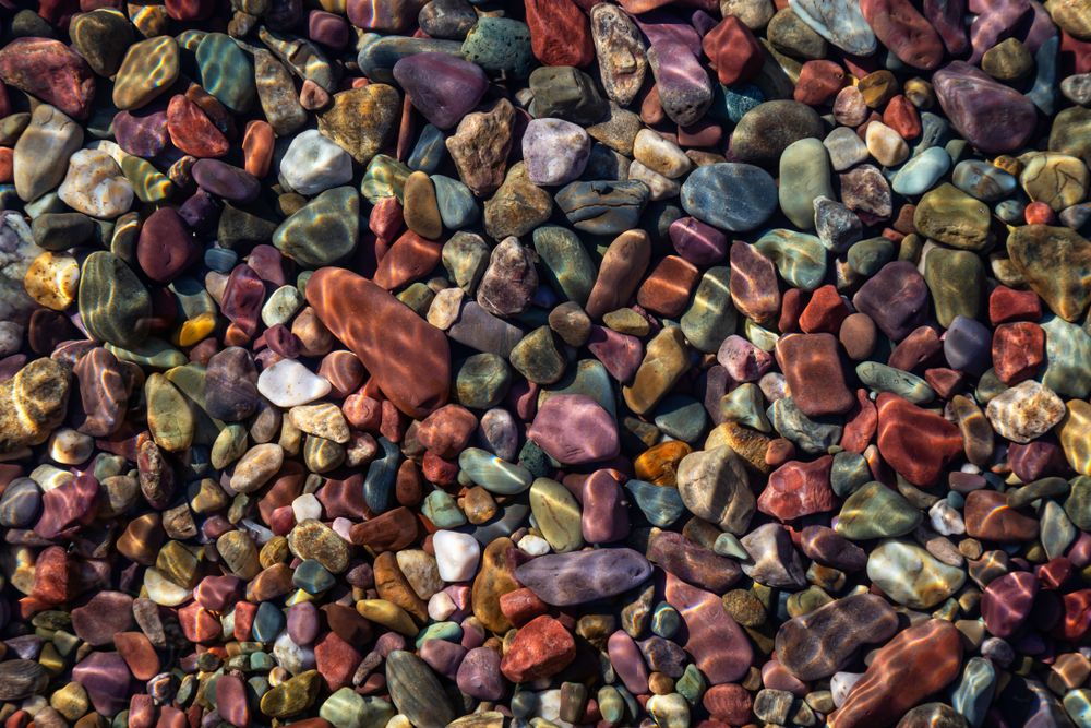 Colorful Rocks in a Glacier Lake during a sunny summer day