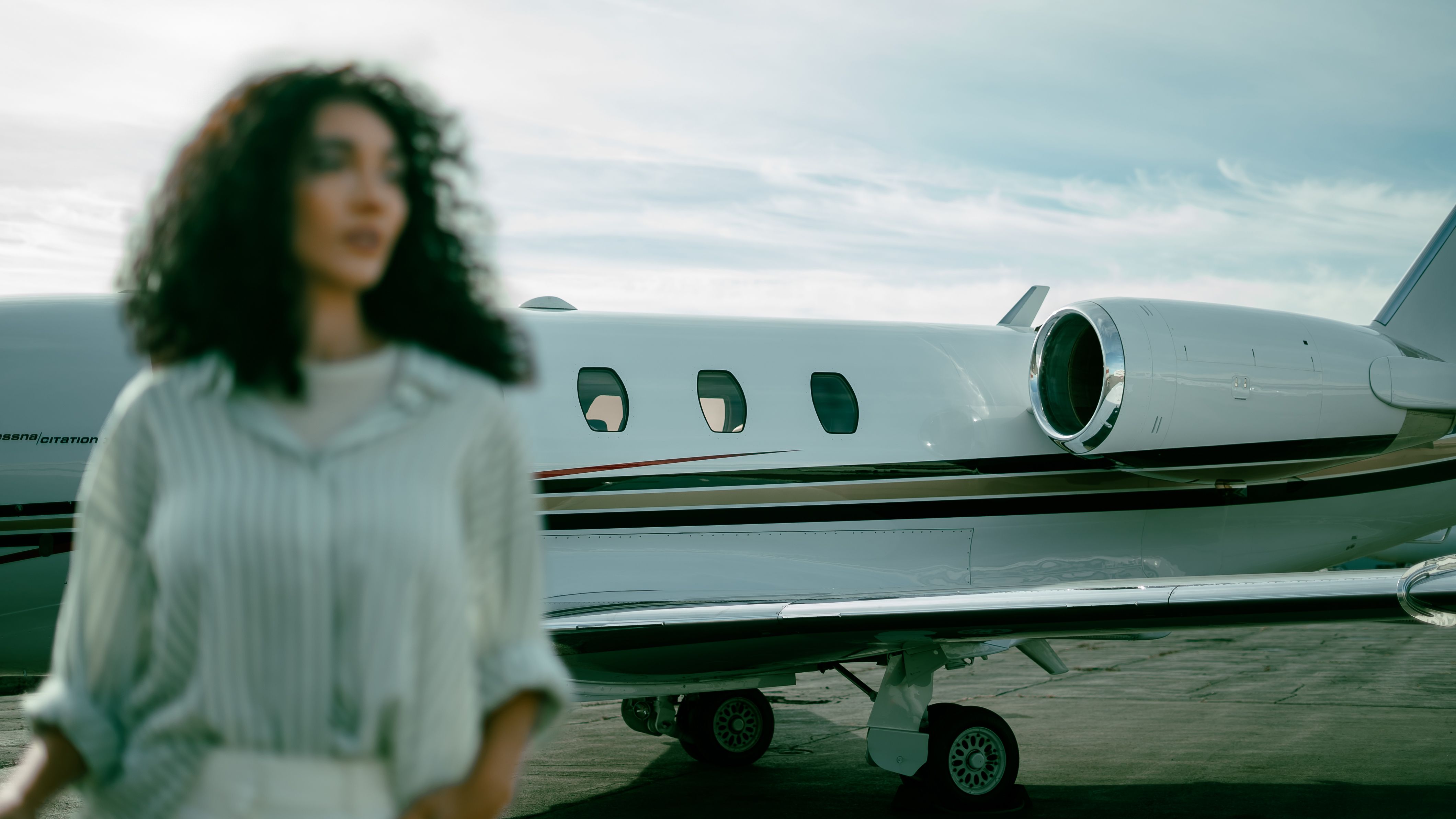 A client stands in front of a privately chartered jet by Flygreen