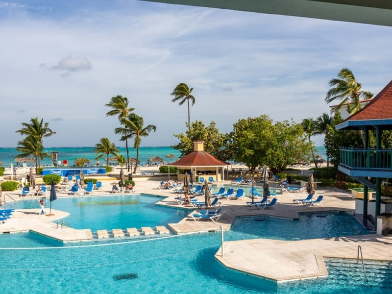Caribbean beach resort with crystal turquoise water, palm trees, and all-inclusive facilities