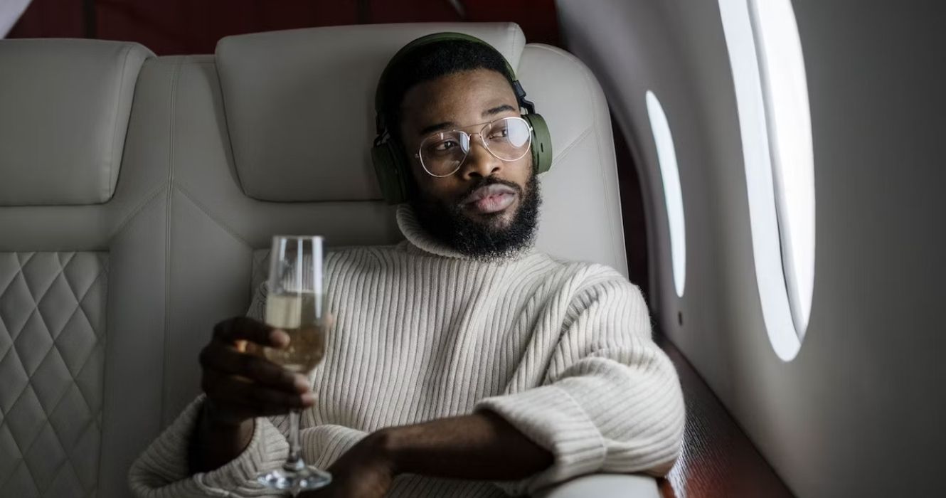 Person drinking champagne on a flight 