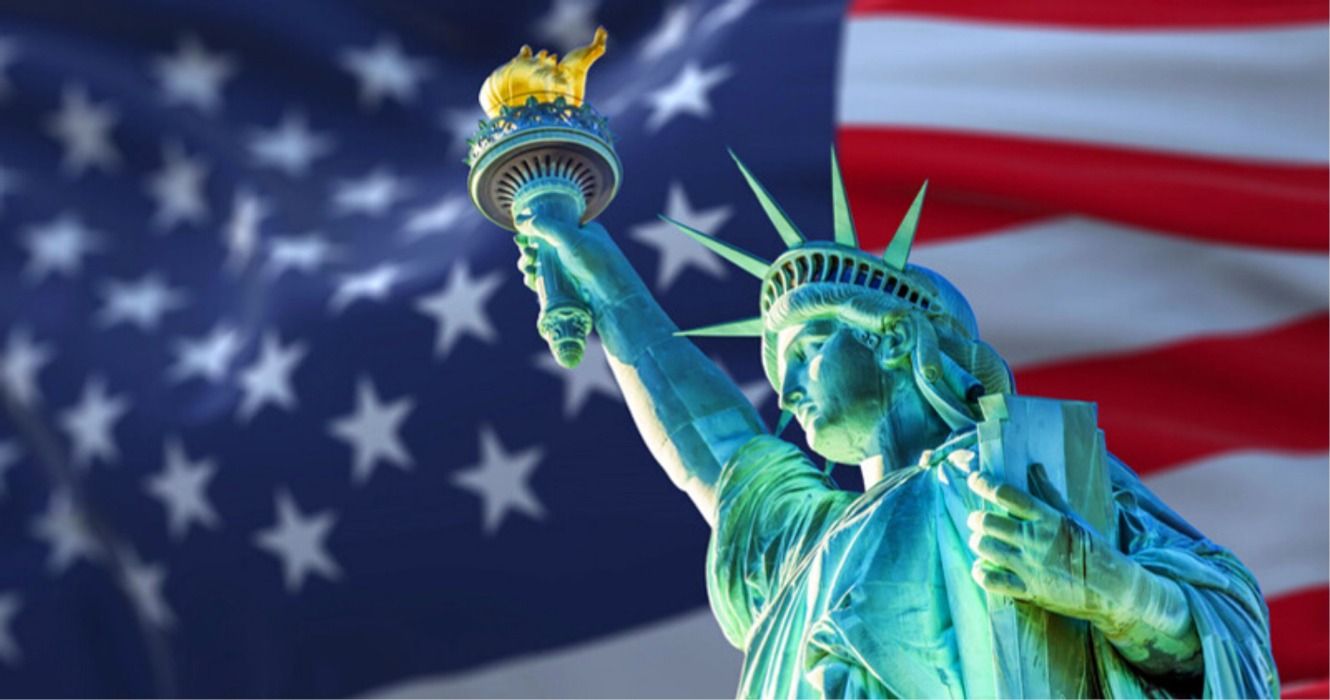 The Statue of Liberty of New York City against the United States of America flag, USA