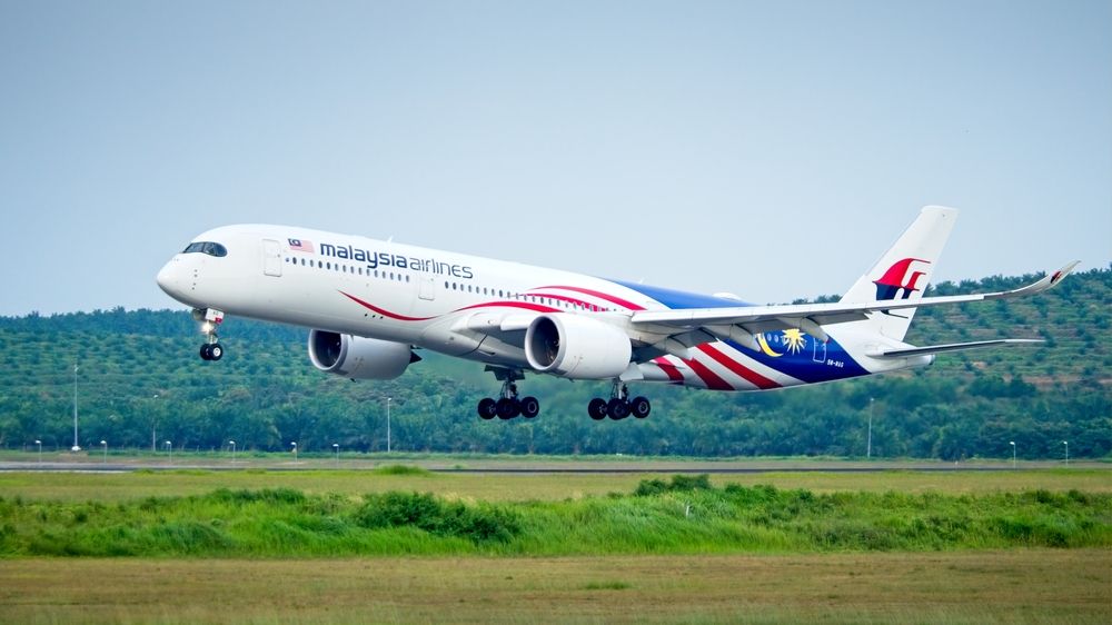 A Malaysia Airlines plane landing at an airport